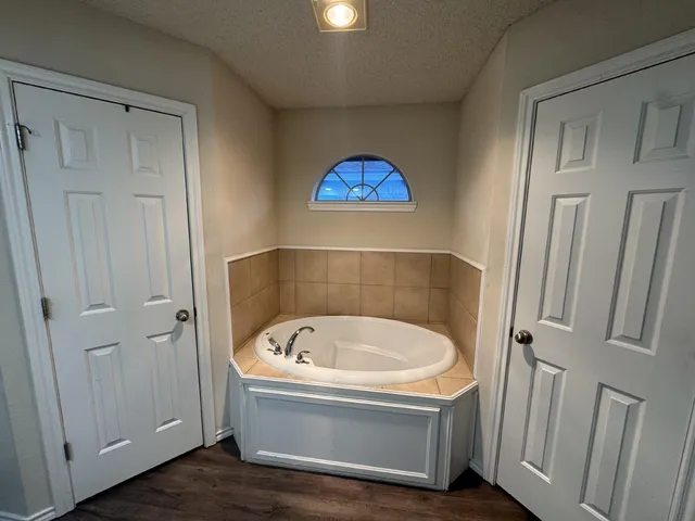 a bathroom with a tub and a shower