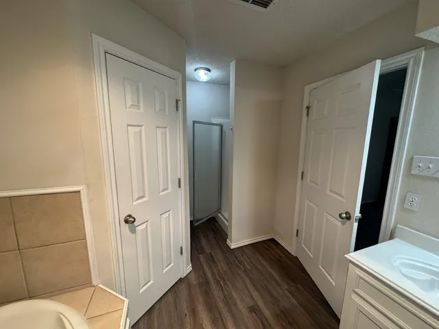 a bathroom with a sink and glass door