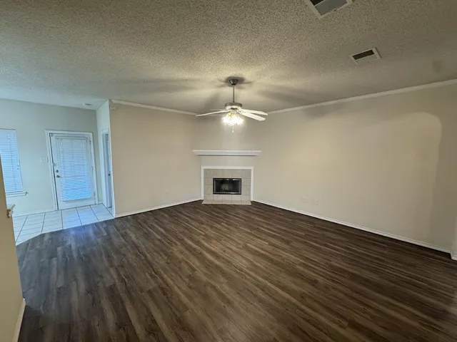wooden floor in an empty room with a fireplace