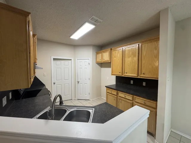 a kitchen with a sink and cabinets