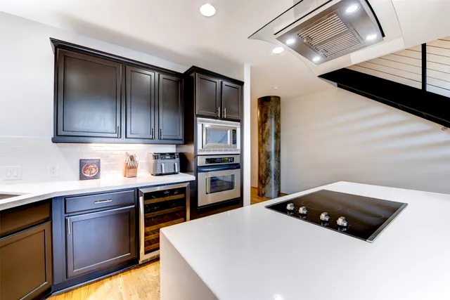 a kitchen with stainless steel appliances a refrigerator and a stove