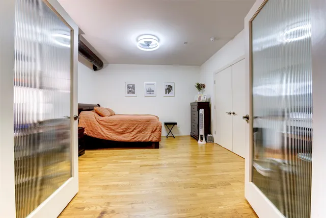 a bedroom with a bed and a shower