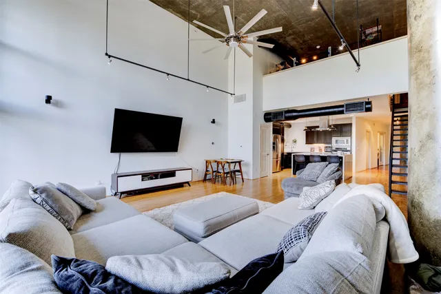a bedroom with furniture and a flat screen tv