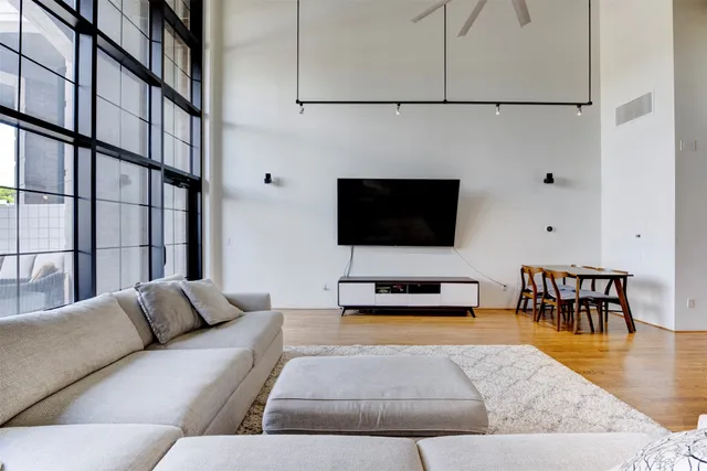 a living room with furniture wooden floor and a flat screen tv