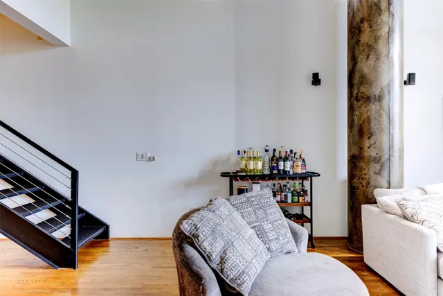 a living room with furniture and a baby crib