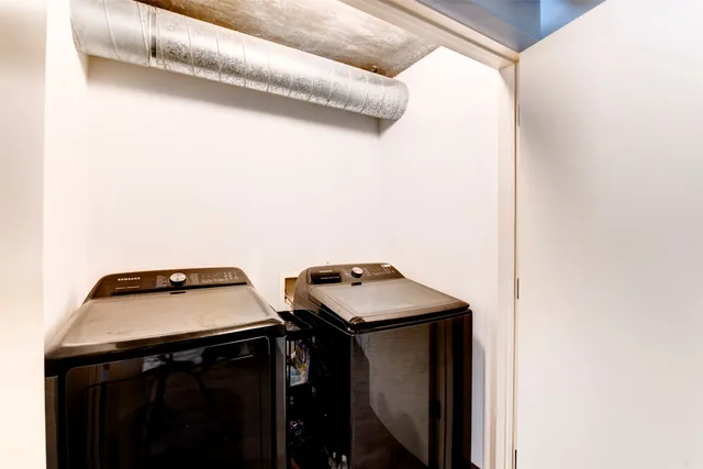 a spacious bedroom with a bed and wooden floor