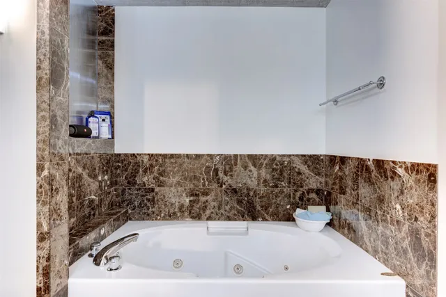 a bathroom with a bathtub and a shower