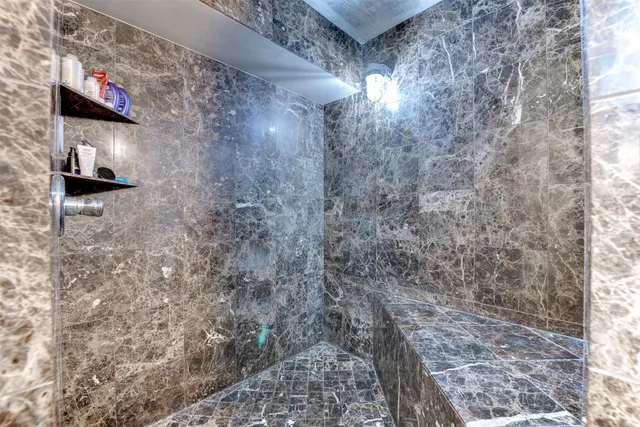 a view of a chairs and table in the back yard of the building