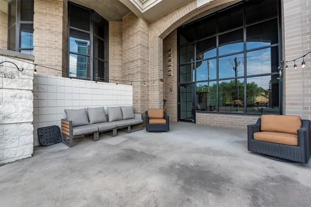 a view of a swimming pool with a patio and plants