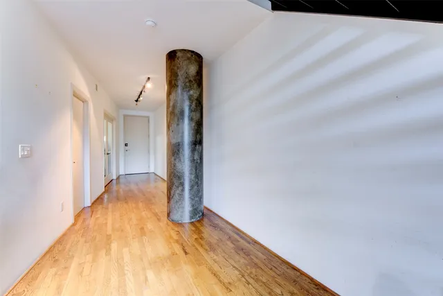 a view of hallway with wooden floor