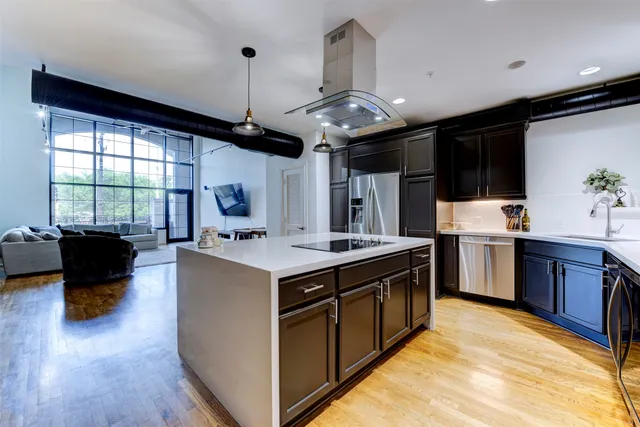 a kitchen with stainless steel appliances granite countertop a stove and a refrigerator