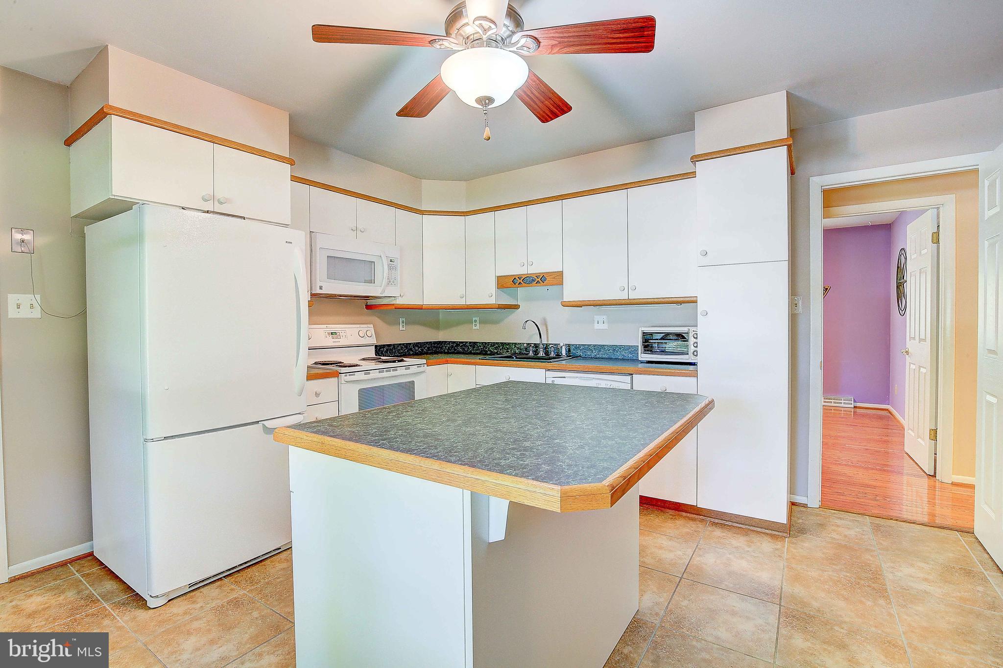 1010 Cox Road Huntingtown, MD 20639 - Photo 15 of 33 a kitchen with stainless steel appliances granite countertop a refrigerator a stove and a sink