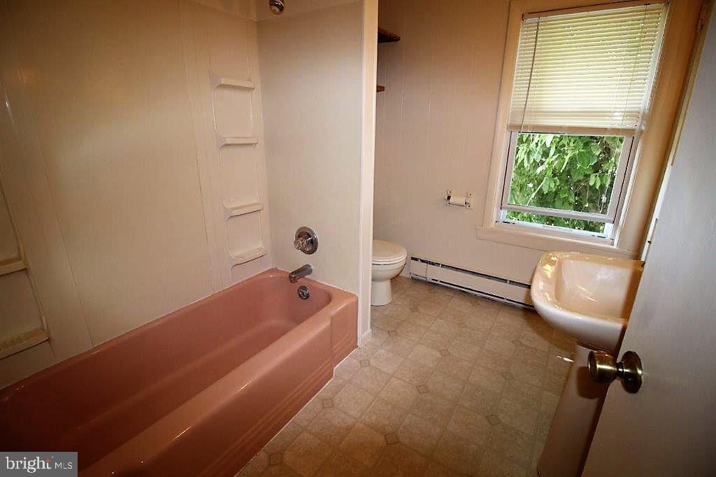 42 B Hatville Road Gordonville, PA 17529 - Photo 6 of 6 a bathroom with a tub a sink and a window