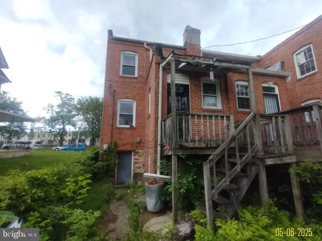a front view of a house with yard and furniture