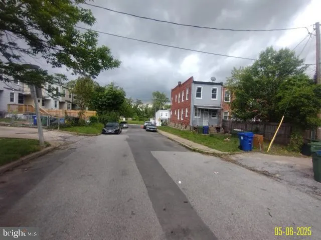 a view of a street with a building and trees
