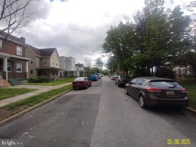 a couple of cars parked in front of a house