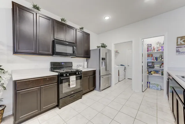 a stove top oven sitting inside of a kitchen