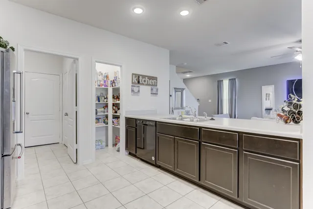 a kitchen with granite countertop cabinets a sink stainless steel appliances and a counter top space