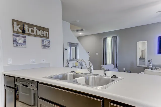 a large kitchen with stainless steel appliances a sink and cabinets