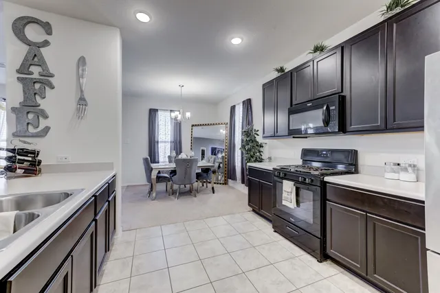a kitchen with stainless steel appliances a sink stove and cabinets