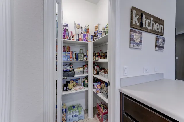 a view of a dining room with furniture and a chandelier