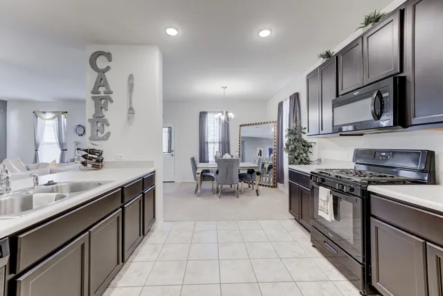 a large kitchen with a table and chairs