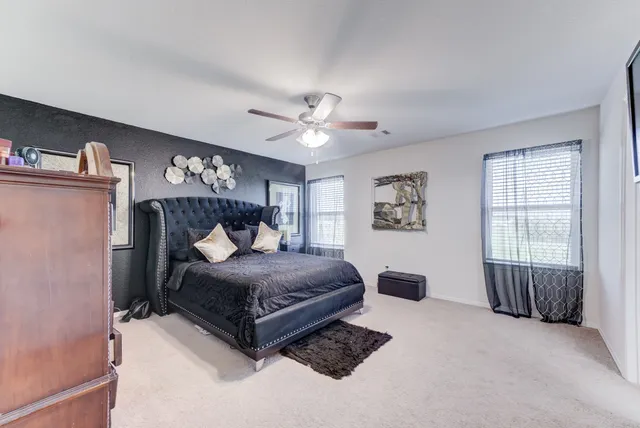a en suite bathroom with a sink double vanity and a mirror