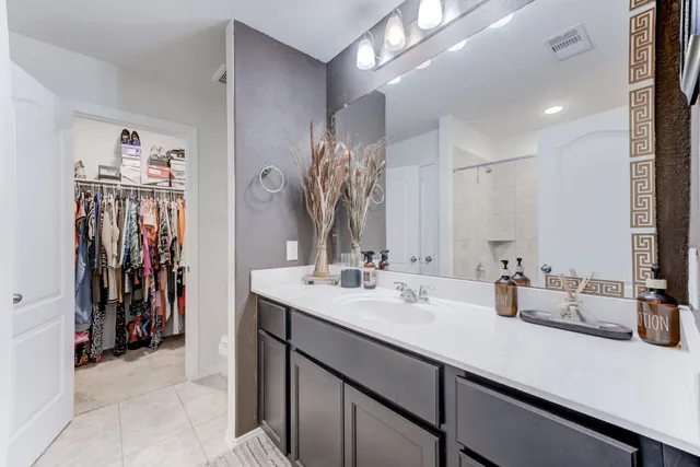 a large bed sitting in a bedroom next to a window
