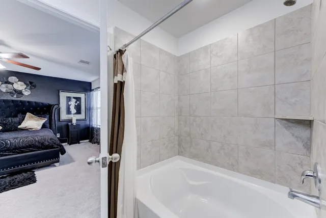 a bedroom with a bed and a television