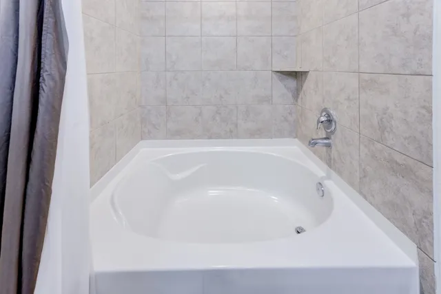 a bedroom with a bed and a television