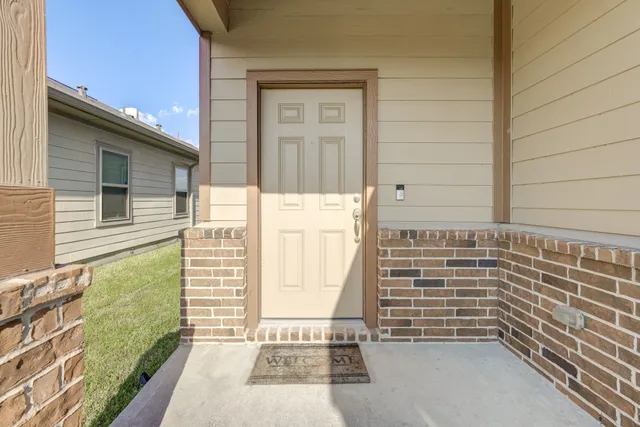 a living room with furniture a kitchen view and a chandelier