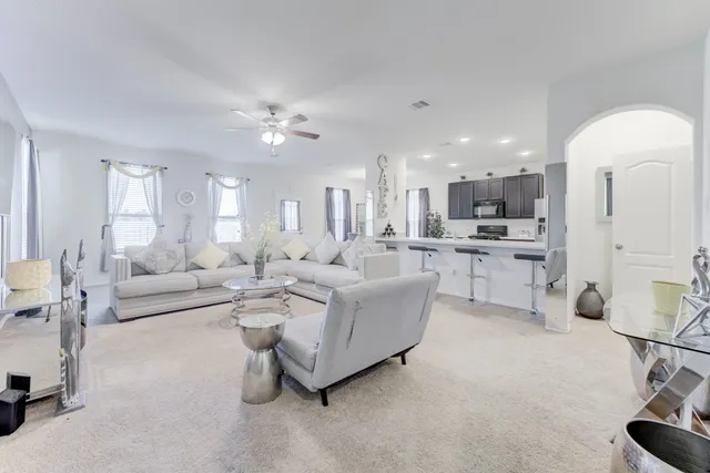 a living room with furniture and kitchen view