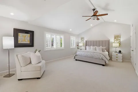 a spacious bedroom with a bed and a window