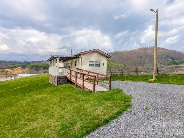 a swimming pool with big yard and big trees