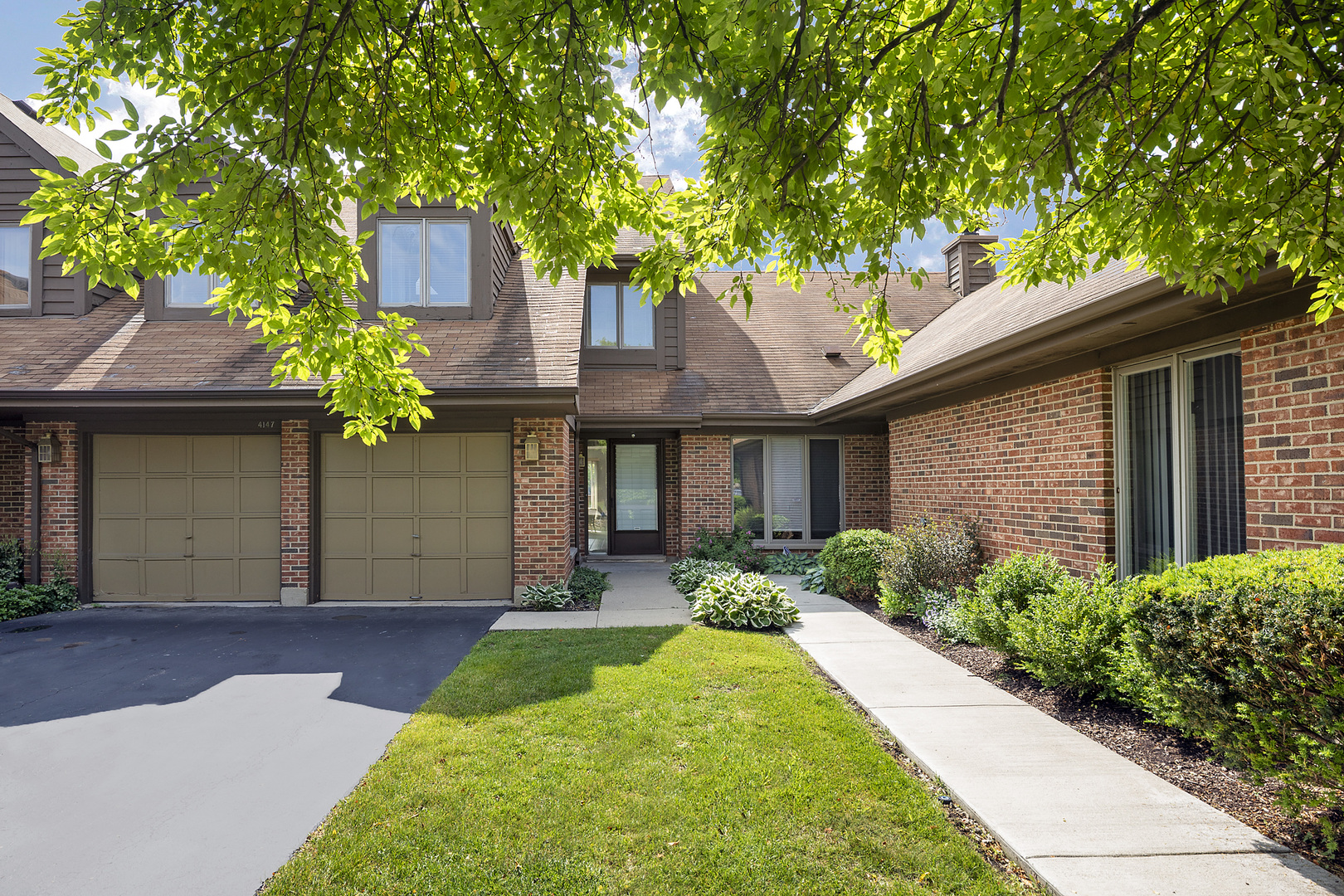 4147 Picardy Circle Northbrook, IL 60062 - Photo 1 of 1 a front view of a house with a yard and trees