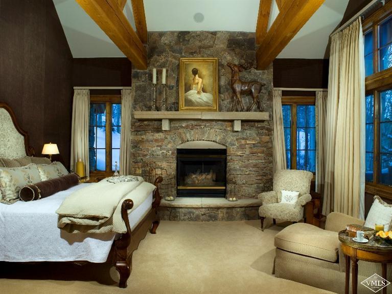 1101 Daybreak Ridge Road Avon, CO 81620 - Photo 6 of 10 a bedroom with furniture and a fireplace