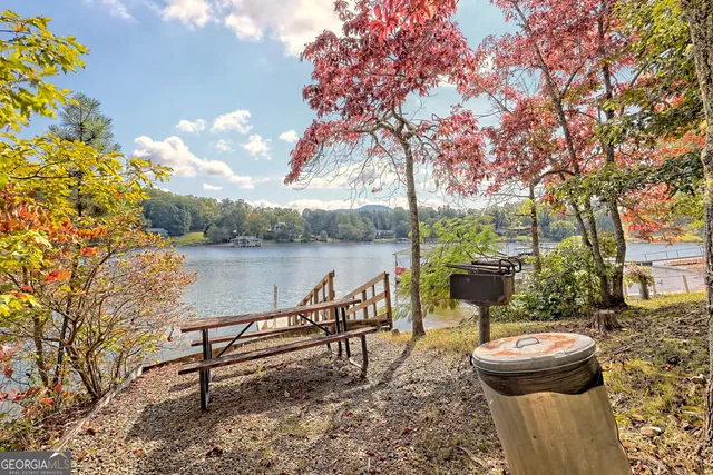 a view of a lake with couches and wooden floor