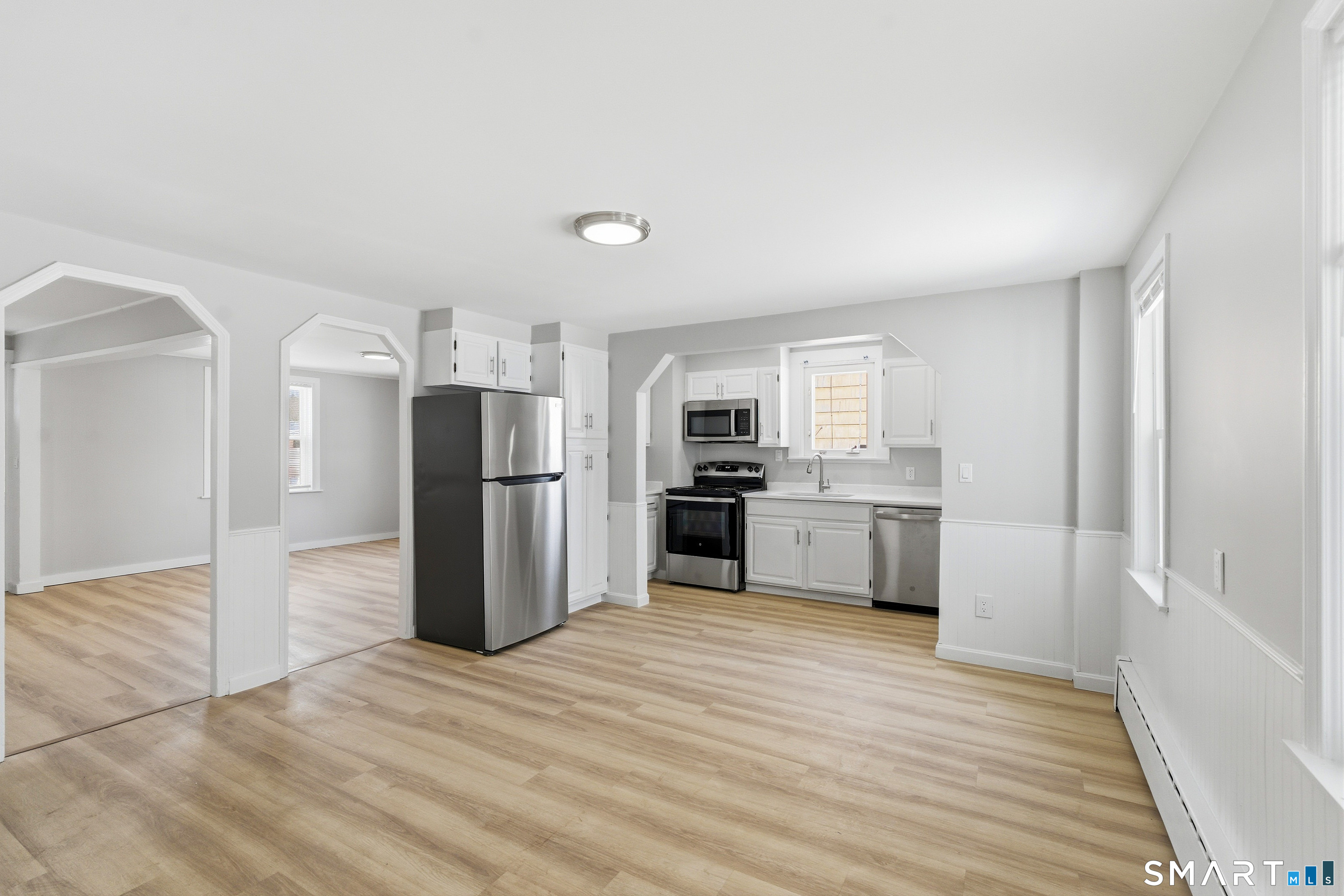 a kitchen with stainless steel appliances a refrigerator and a stove top oven
