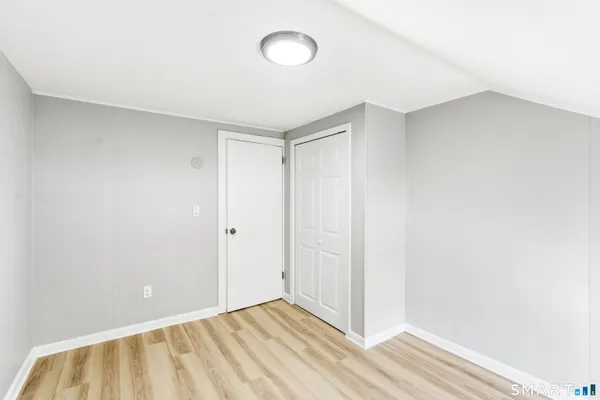 a view of an empty room and wooden floor