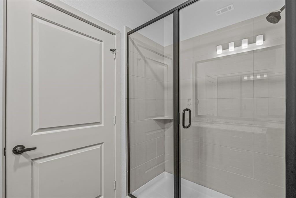 3120 East Park Row Drive, Unit 4312 Arlington, TX 76010 - Photo 9 of 11 a bathroom with a glass shower door