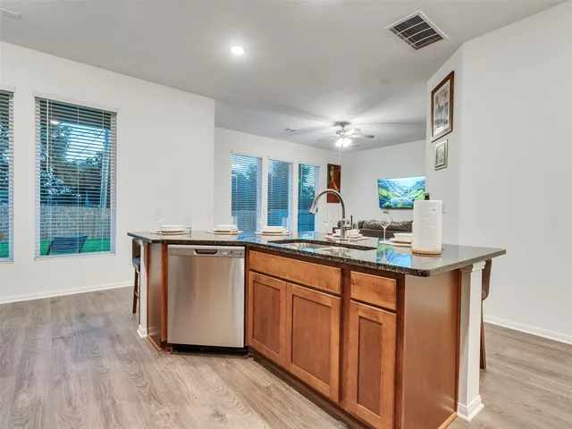 a kitchen with stainless steel appliances granite countertop a stove a microwave and cabinets