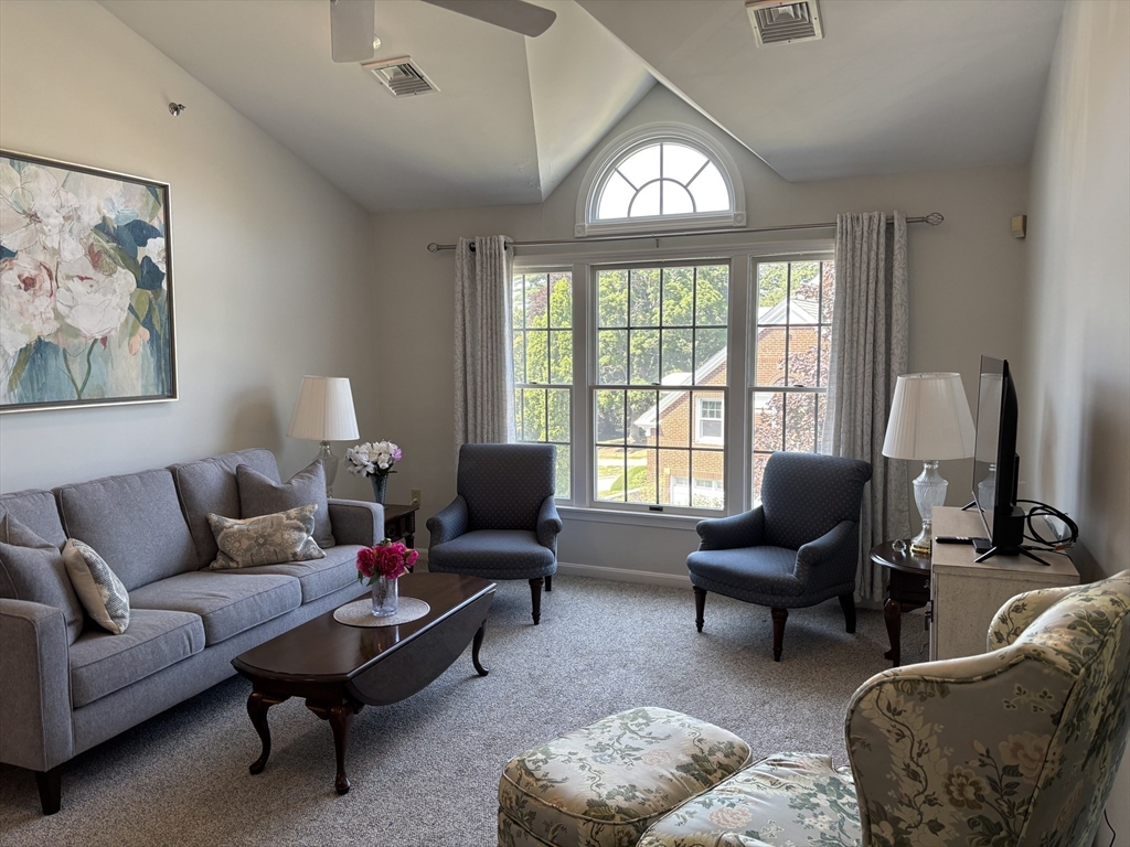 807 Old Country Road, Unit 807 Wenham, MA 01984 - Photo 1 of 13 a living room with furniture and a large window