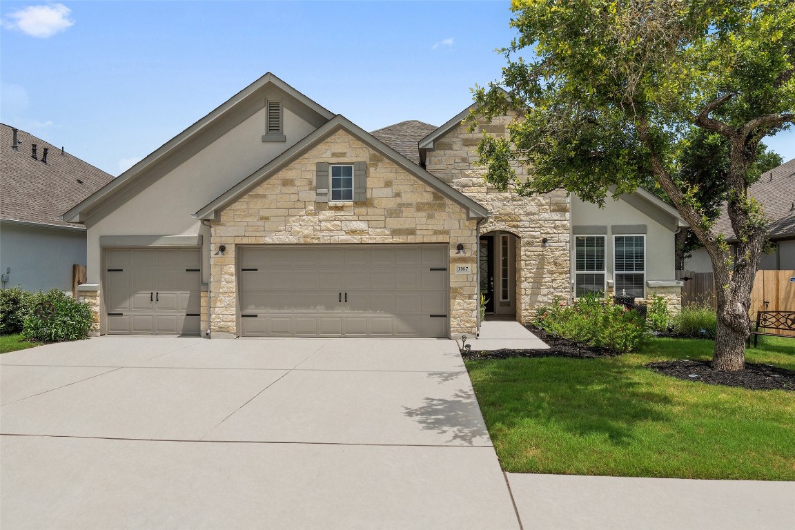 1167 Arrowhead Ranch Boulevard Dripping Springs, TX 78620 - Photo 1 of 1 a front view of a house with a yard and garage