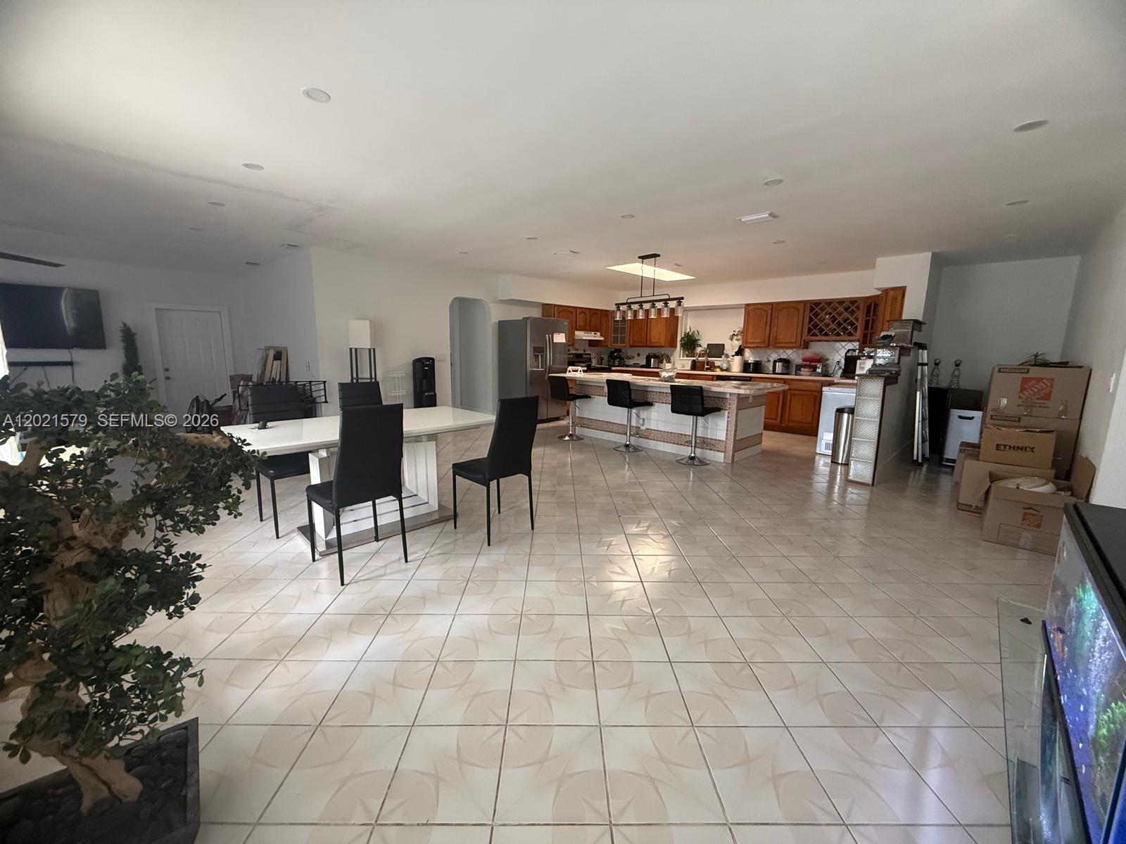22445 Southwest 264th Street Homestead, FL 33031 - Photo 2 of 12 a living room with furniture and a dining table with kitchen view