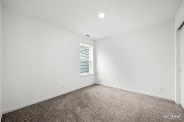 a bedroom with a bed and a chair