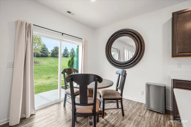 a view of a dining room with furniture and a window