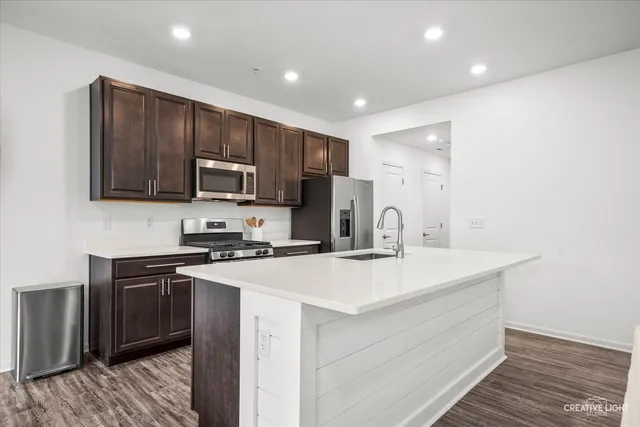 a kitchen with a sink a stove and refrigerator
