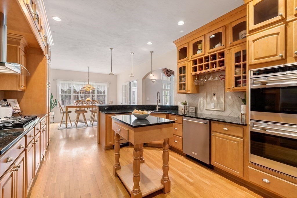 5 Rolling Meadow Drive Millis, MA 02054 - Photo 13 of 42 a kitchen with stainless steel appliances granite countertop a stove and a wooden floors