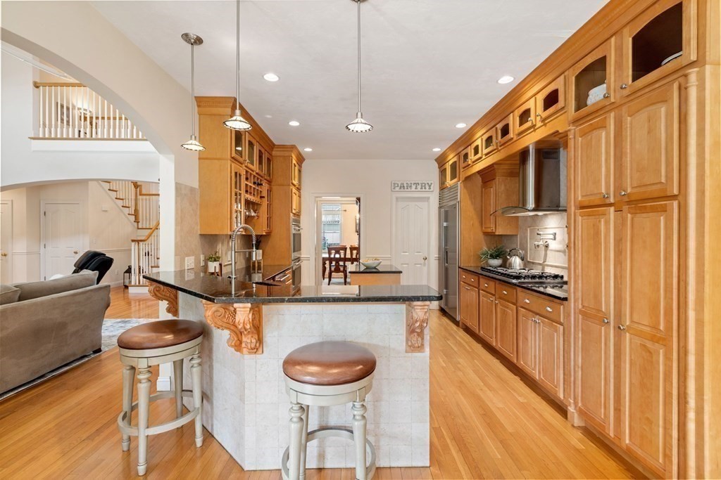 5 Rolling Meadow Drive Millis, MA 02054 - Photo 14 of 42 a kitchen with stainless steel appliances granite countertop a sink and a refrigerator
