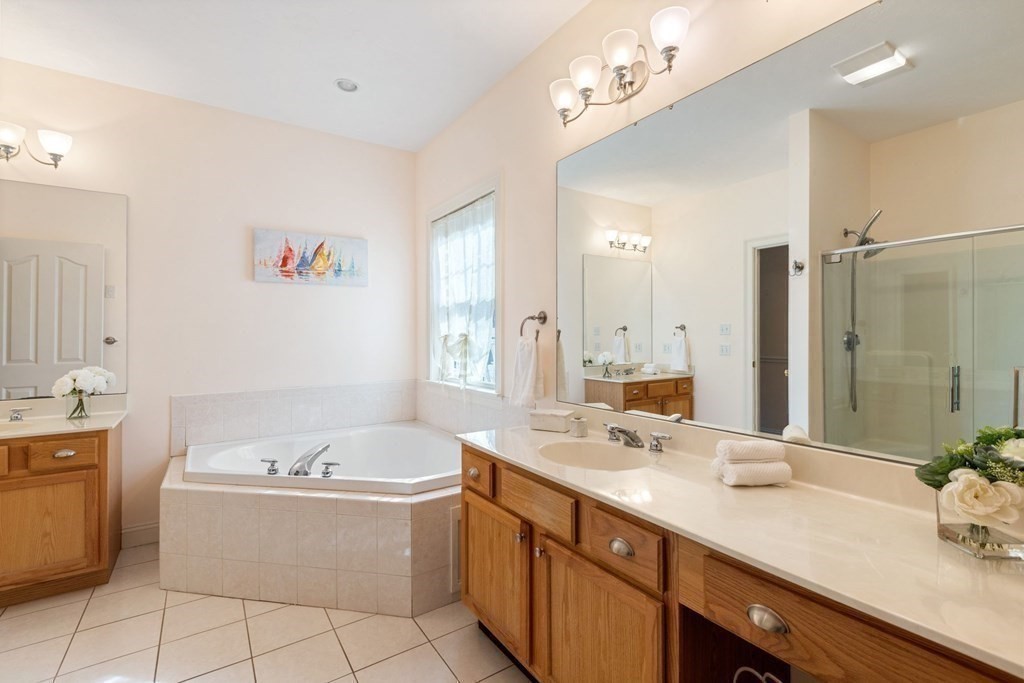 5 Rolling Meadow Drive Millis, MA 02054 - Photo 23 of 42 a bathroom with a tub a double vanity sink and mirror
